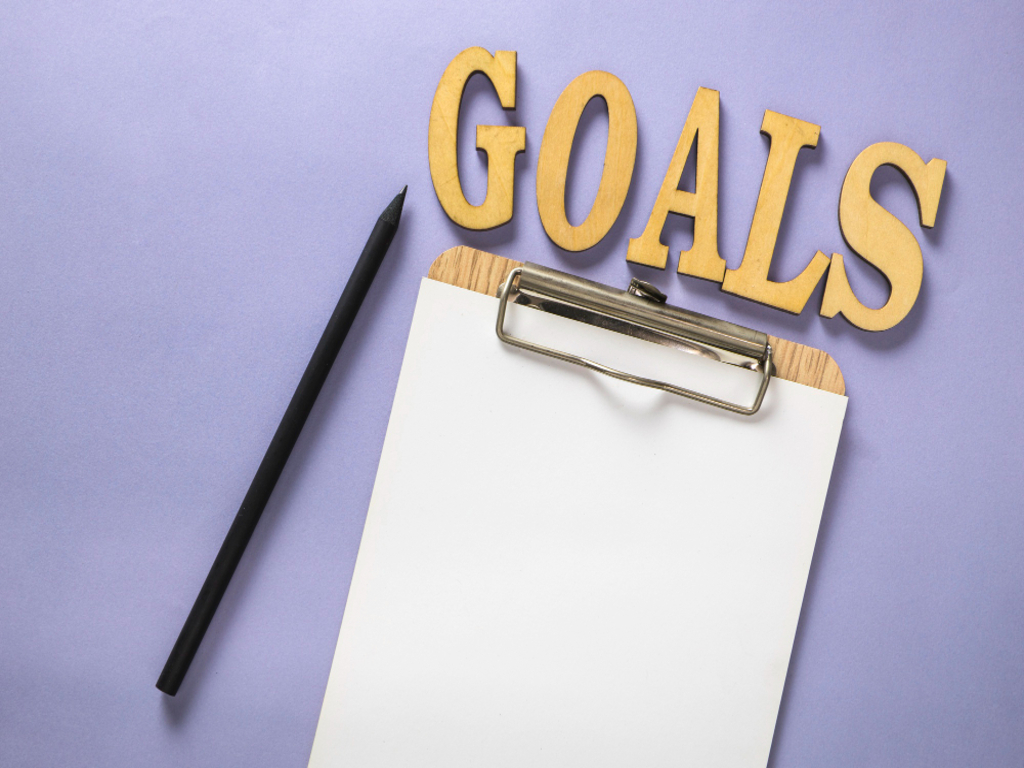 Close-up shot of a vision board with images and quotes that inspire motivation, illustrating the concept of focus on goals in personal development.